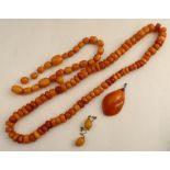 A graduated amber bead necklace, the beads of squat disc form, together with a string of amber