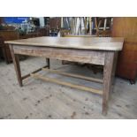 A pine rectangular kitchen table, raised on four square tapering legs, united by a stretcher,