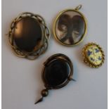 A 19th century memorial oval locket, containing hair locks with gold thread, engraved at the back "