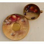 A Royal Worcester miniature cup and saucer, the interior of the cup and the saucer decorated with