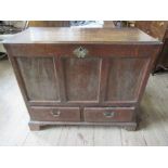An Antique oak mule chest, having rising lid over two short drawers, also having a side panel