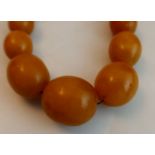 A string of Graduated Amber beads, the largest bead approximately 29mm x 24mm, 102 grams
