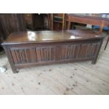 An Antique oak coffer, having four carved fielded panels to the front, width 57ins, depth 17ins
