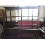 A large Antique oak dresser, having a plate rack over the dresser base, fitted with four short