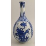 A Chinese Kangxi vase, decorated with panels of foliage with flower head reserves, bearing a