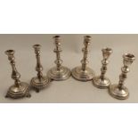 Two pairs of hallmarked silver candlesticks, marks rubbed, heights 7ins and 6ins, together with