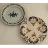 Two Delft pottery wall plates, one decorated in blue with a basket of flowers, the other with swags,