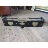 An Arts and Crafts style fender, with heart motifs, width 42ins