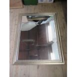 A rectangular mirror within a moulded silvered frame mirror size 45.5ins x 34.5 ins
