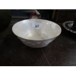 A white bowl with embossed decoration