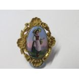 An enamel brooch, with image of woman in national dress, believed to be Swiss, marked Zug, in an