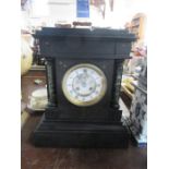 A Victorian black slate mantel clock
