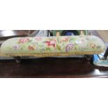 A tapestry topped foot stool