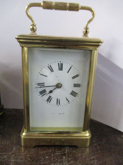 A brass carriage clock, height 6ins including handle