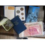 A collection of commemorative coins and bank notes