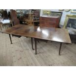 A 19th century mahogany extending gate leg dining table, made up of two sections, raised on turned