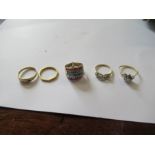 A 22ct gold band, weight 2g, together with two 18ct gold gem set rings, weight 4g, another gem set