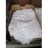 A box of linen table cloths etc