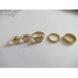 Two 22ct gold wedding bands, weight 9g, together with a 15ct gold signet ring, weight 2g and two