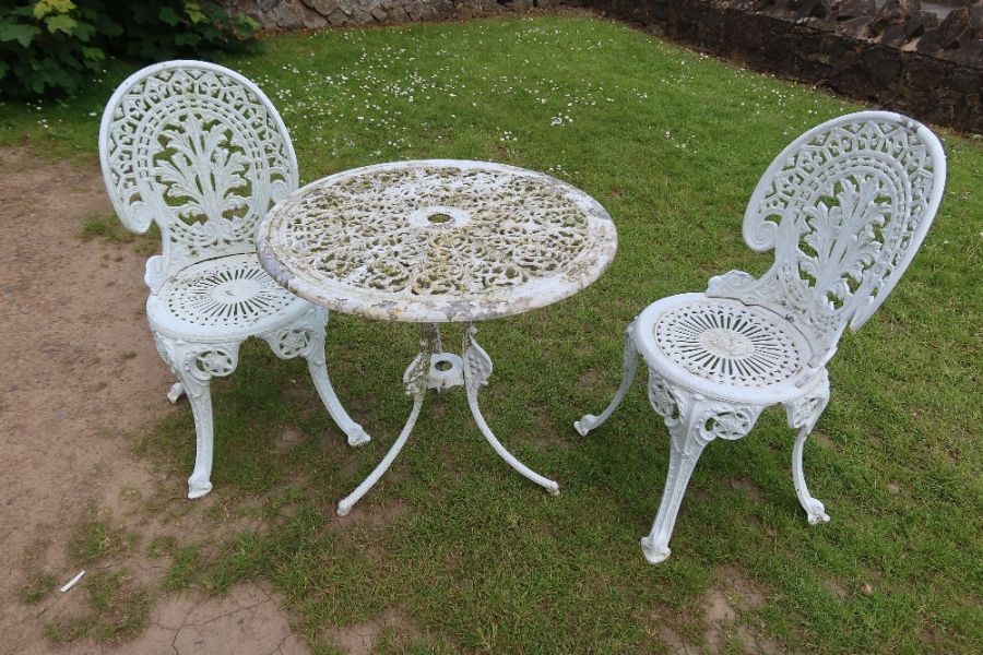 A garden table and two matching chairs