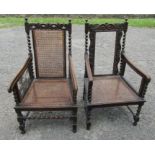 A pair of carved oak and cane armchairs