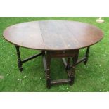 An Antique oak gateleg dining table, fitted with a drawer, 42ins x 56ins, height 27ins