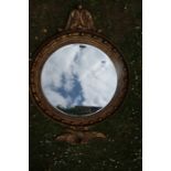 A Regency design circular mirror with eagle finial and beveled plate total width 37ins total