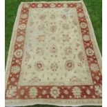A modern rug, decorated with flowers, 83ins x 59ins