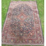 An Eastern design rug, the blue ground field decorated with flowers to a red ground border, 81ins