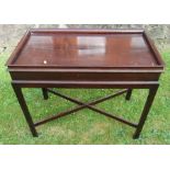 A 19th century mahogany rectangular table, with tray top and cross stretcher, 33ins x 18ins,