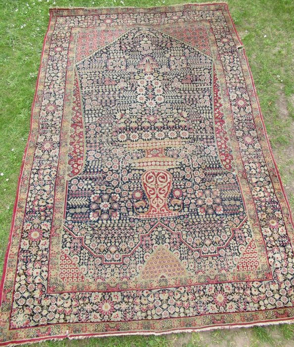 An Eastern design pray rug, the field decorated with a vase of flowers, 56ins x 84ins, together with