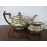 A silver tea pot and matching sugar bowl, with gadrooned decoration, engraved with initials, Chester
