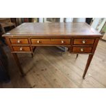 An Edwardian desk with leather inset top with cheeker band and cross band inlay width 42ins,