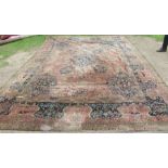 A large rug, decorated with urns, animals and flowers, with similar border, 135ins x 180ins