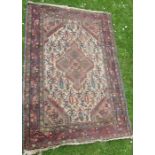 An Eastern design rug, with diamond to the white ground field, 40ins x 60ins