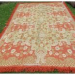 An orange and beige bedspread, with tassels to all edges, 100ins x 150ins