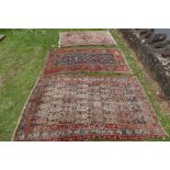 Three Eastern design rugs all having geometric and foliage decoration 46ins x 74ins, 43ins x 73ins ,