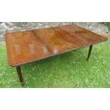 A 19th century extending dining table, raised on reeded legs, 67ins x 45ins, height 28ins, without