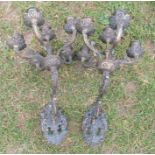 A pair of metal six light wall candle holders