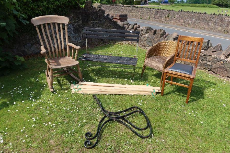 A collection of chairs to include folding bench, bench ends, Windsor rocker, Lloyd Loom style