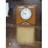 A leather cased travelling clock