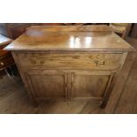 An oak wash stand fitted with one drawer over cupboard doors width 36ins, height 31ins