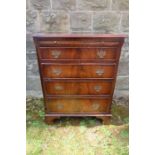 A reproduction chest of drawers having sliding tray over four graduated doors width 255ins, height