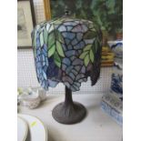 A Tiffany style table lamp, the column formed as a tree, with stained glass shade, height 22ins