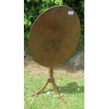 A 19th century mahogany oval tripod table, with hinged top