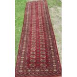 An Eastern design red ground runner, 38ins x 126ins