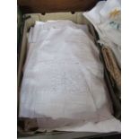 A box of linen table cloths etc