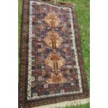 An Eastern design blue ground rug, with beige ground to the lozenges, 80ins x 45, together with a