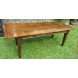 An elm refectory dining table, the three plank top with cleated ends raised on square tapering legs,
