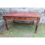 A 19th century writing desk having red leather inset, raised on reeded legs, fitted with 3 frieze